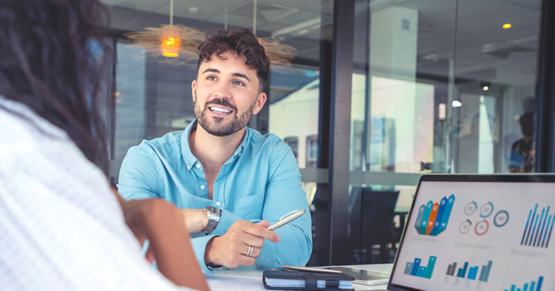 Man talking to his colleague about marketing data