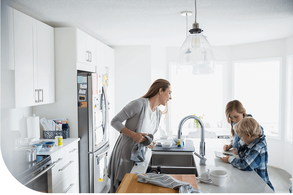 Woman talking to her children in the kitchen