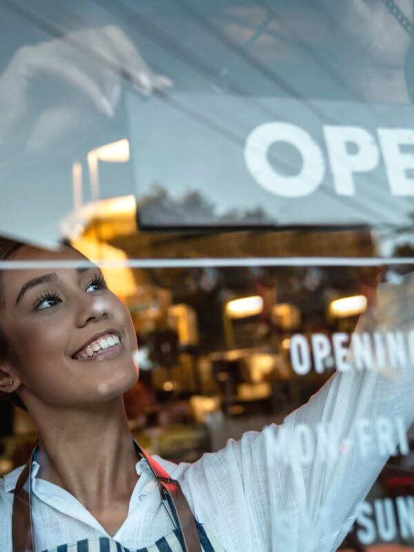 Woman opening up her shop for business