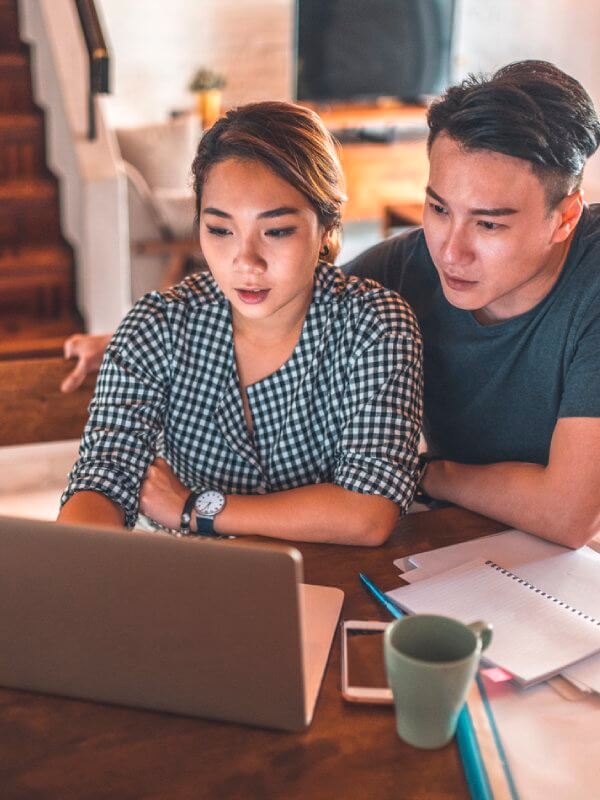 Couple looking through products on their laptop