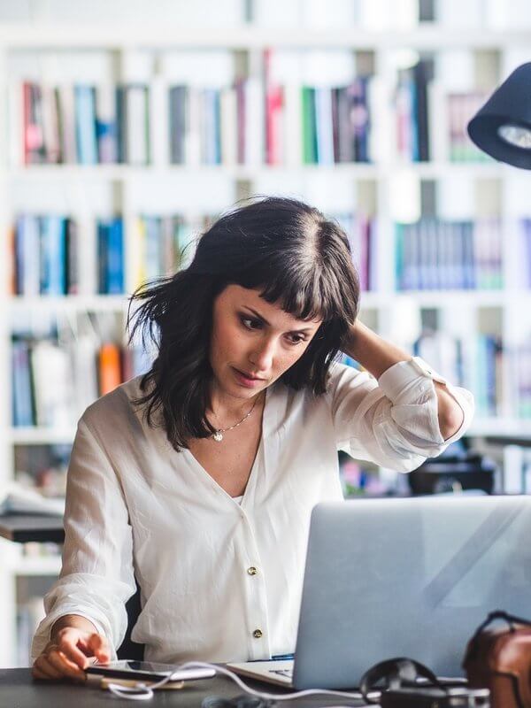 Woman in library looking concerned
