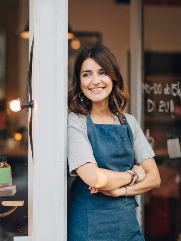 Small business owner smiling in their store