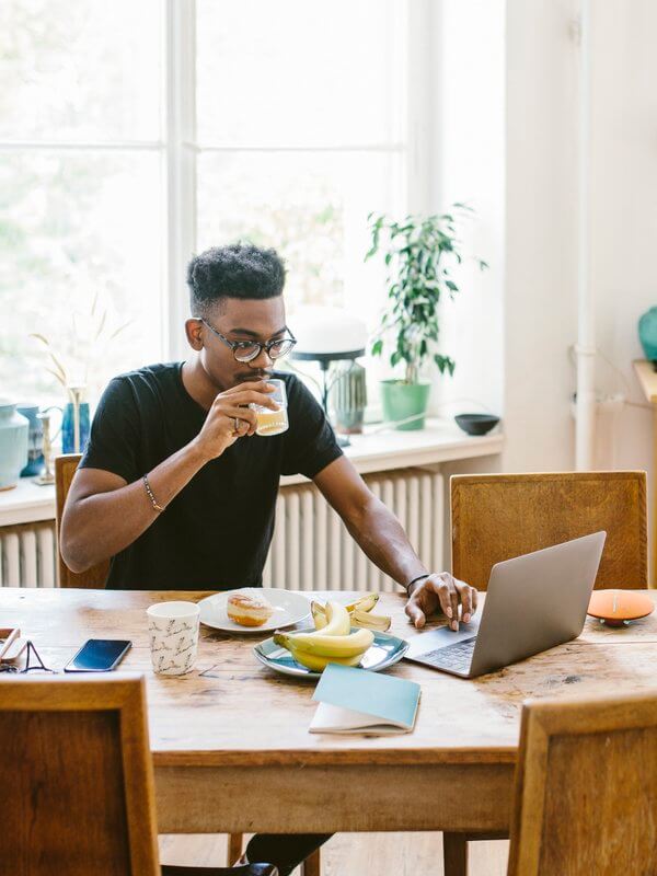 Young man looking relaxed while using his CRM system