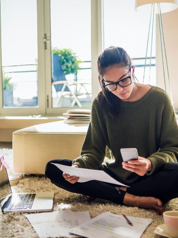 Woman working from home assessing risk scores