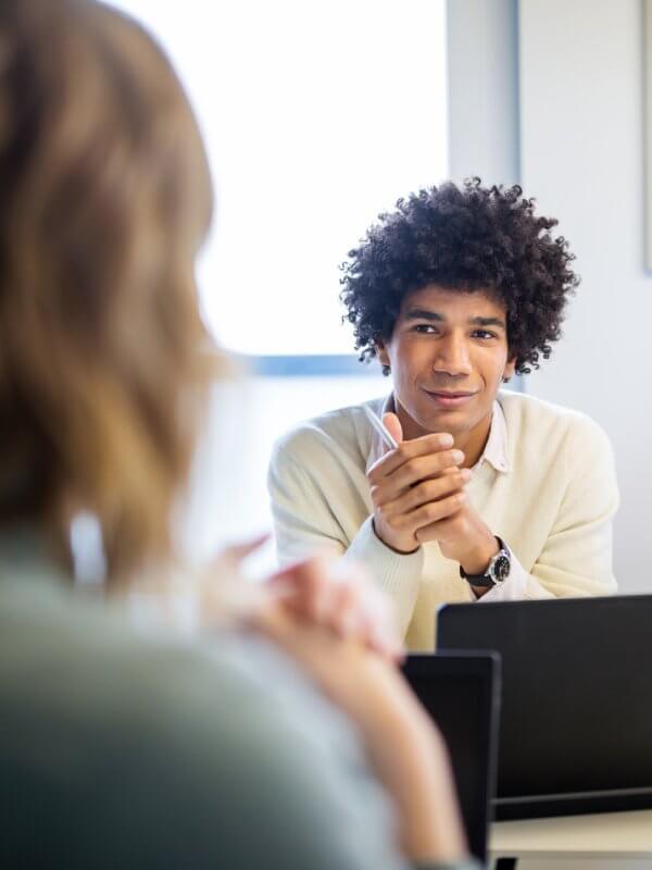 Two colleagues talking in a team meeting