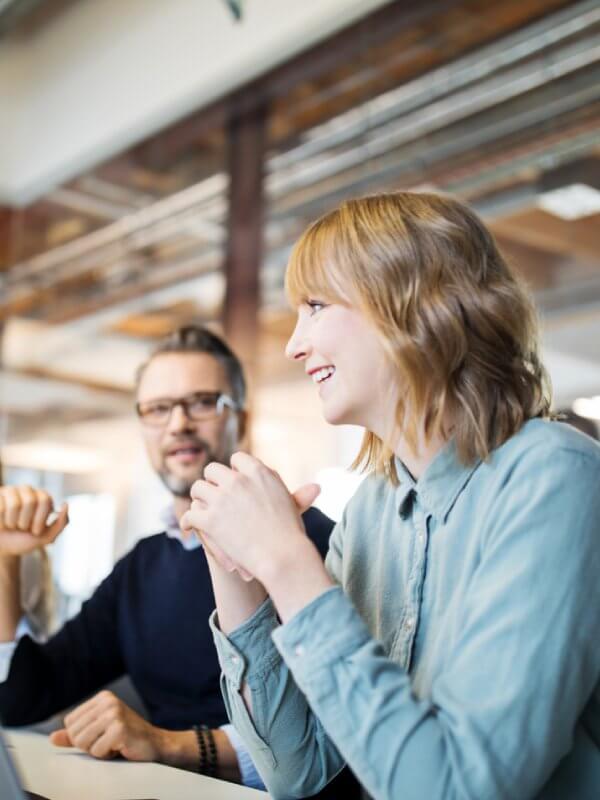 Two colleagues talking in a team meeting