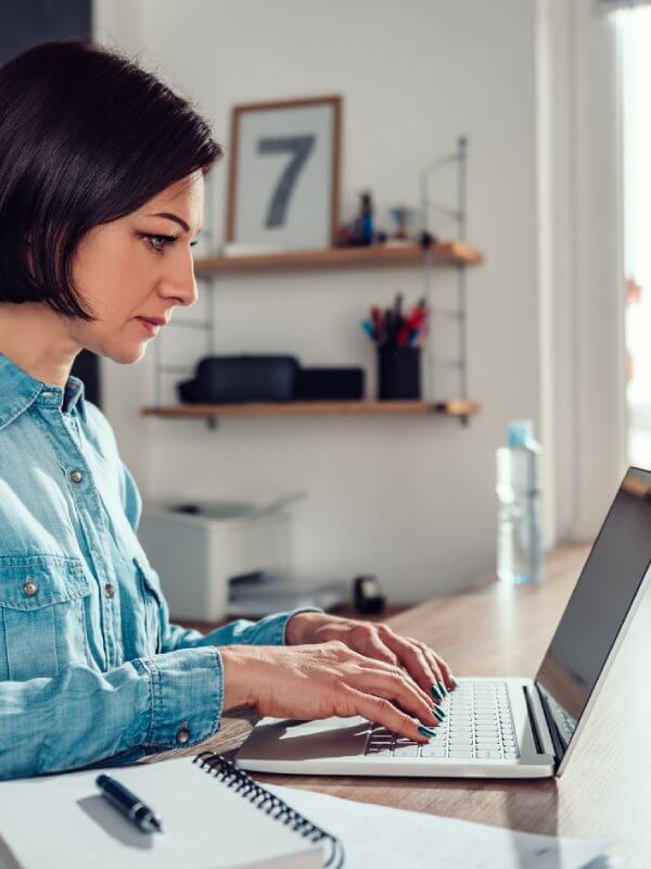 Woman using her laptop to upload her audience to a publisher