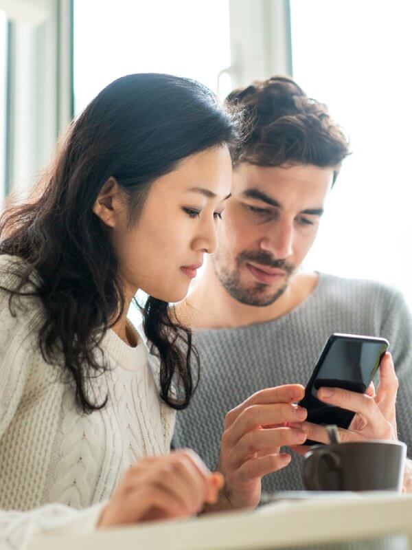 Young couple applying for credit on a mobile phone