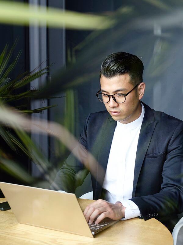 Businessman using his laptop to share credit performance