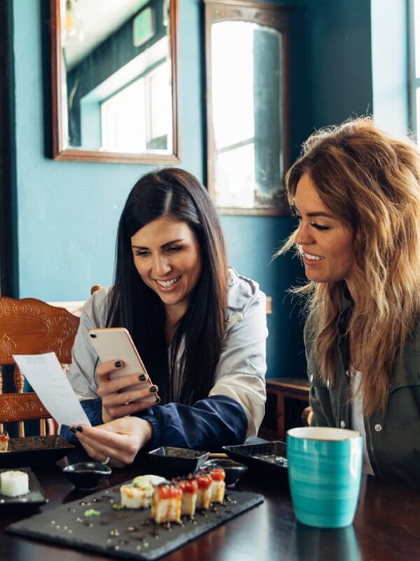 Two young women talking in a coffee shop