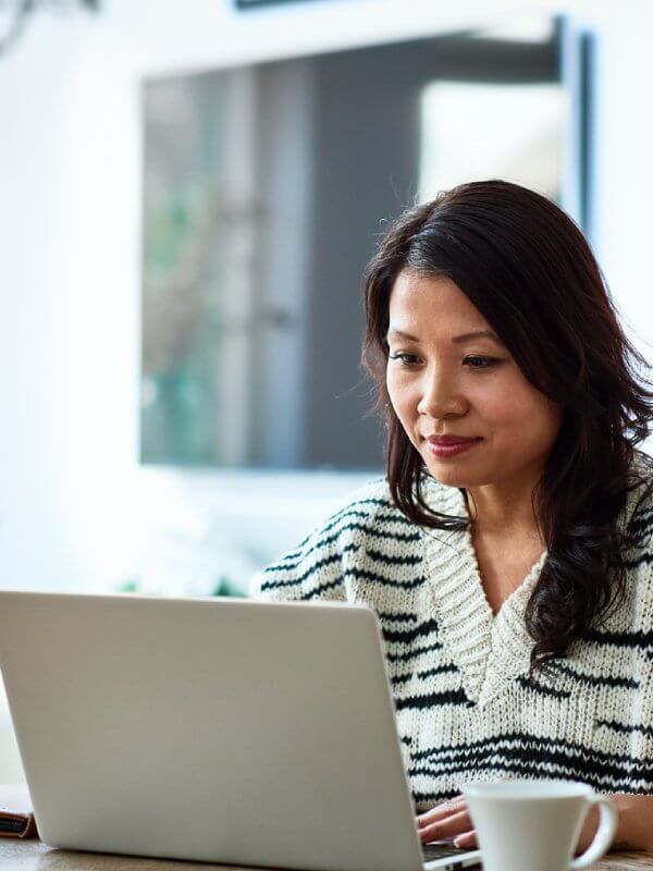 Woman auditing her customer contact database on her laptop