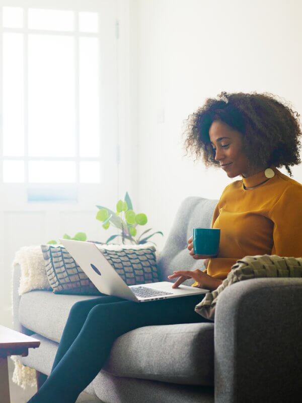 Young woman working from home with her laptop