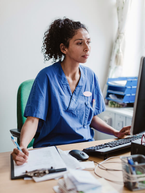 Doctor making notes on clipboard