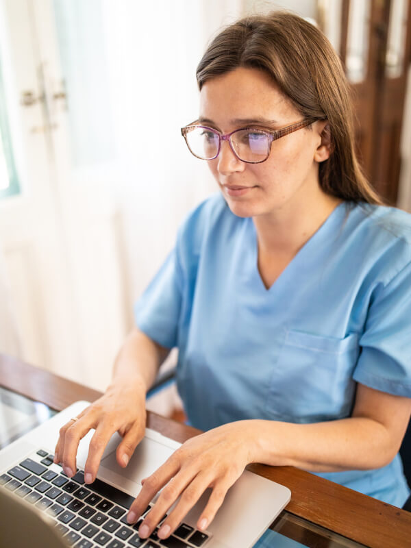 A nurse looking at the patient database