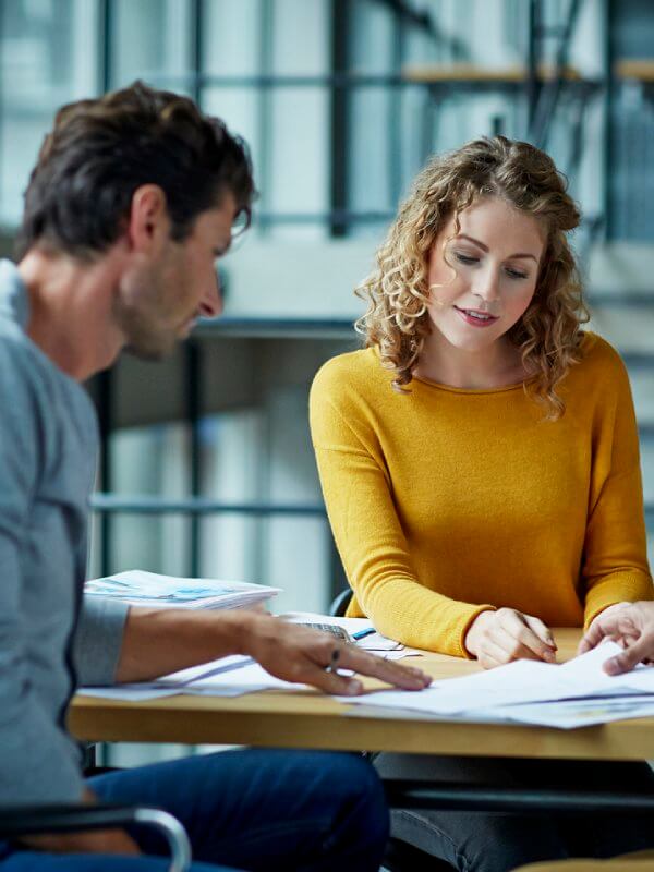 Government colleagues in an office assessing debtors