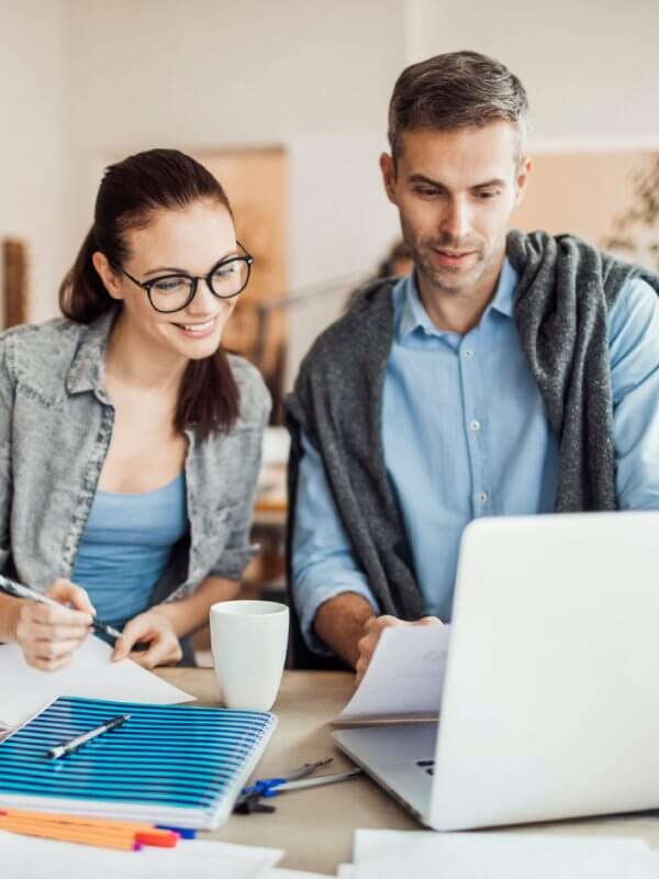 Two colleagues looking at data on a computer