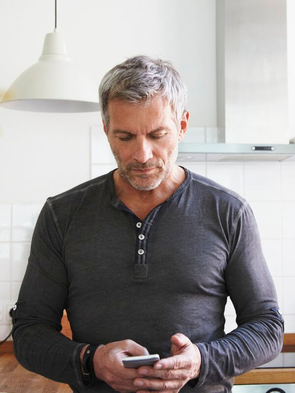 Mature man looking at his mobile phone