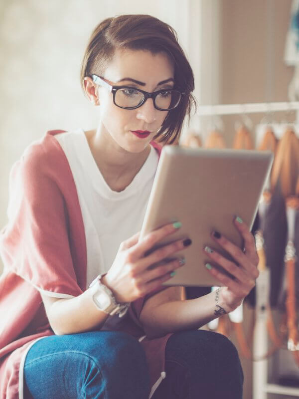 Young business owner looking at a tablet