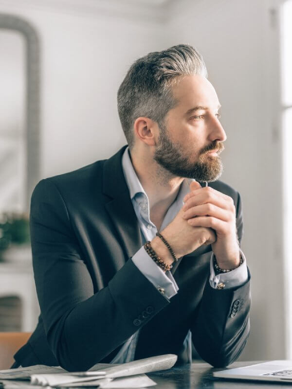 Businessman looking out of the window of his office