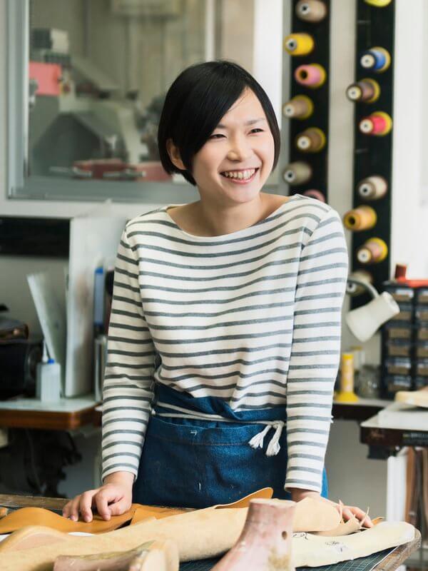 Small business owner smiling in their store