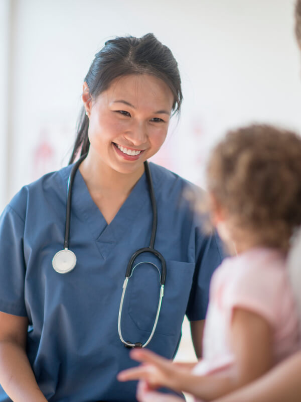 A junior doctor talking to a young patient