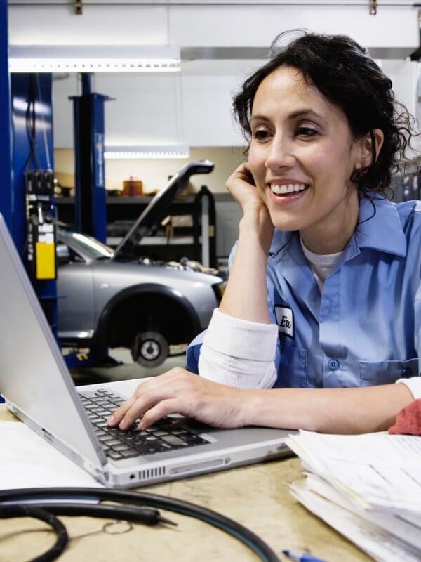 Garage mechanic looking on the company's database