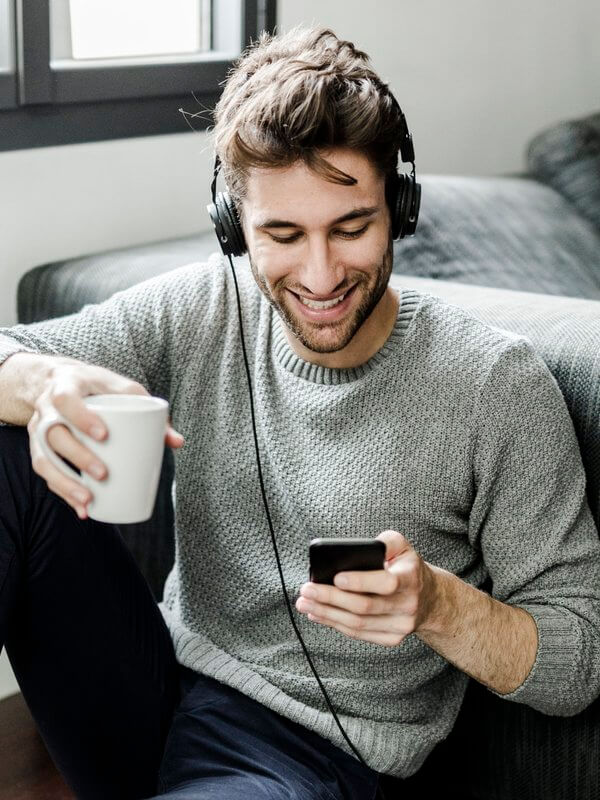 Man smiling while listening to music
