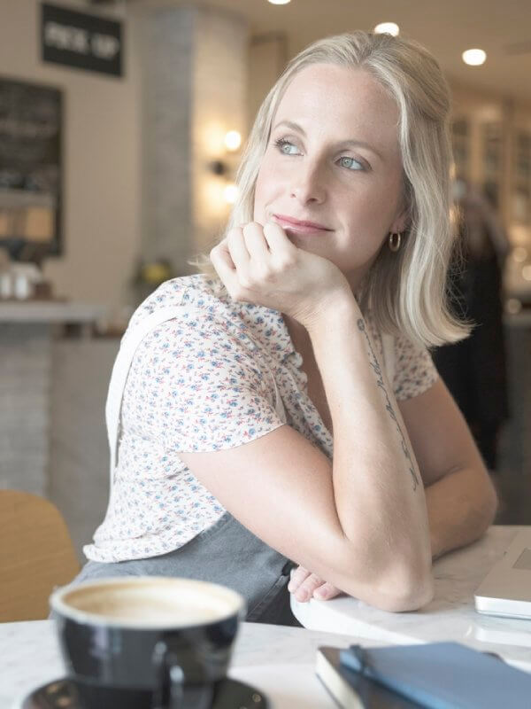 Woman deep in thought while sat in a cafe
