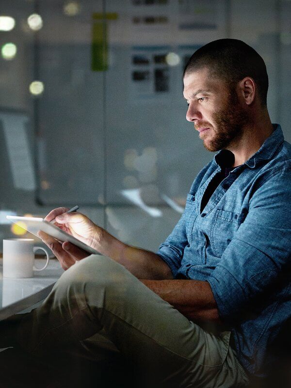 Man using a tablet to gain a deeper understanding of customer data