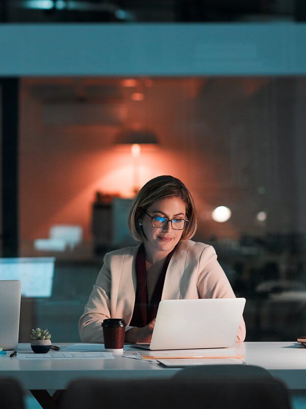 Smartly dressed woman working late in an office
