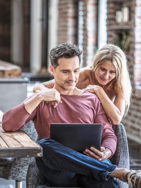 Couple on the laptop verifying their details