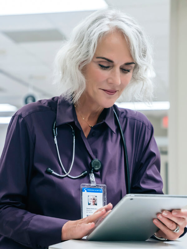 Senior consultant analysing patient data