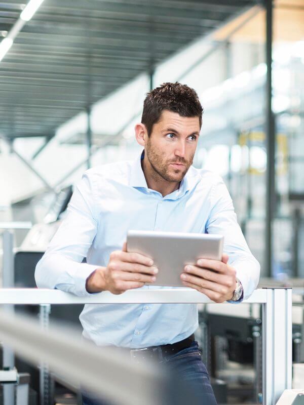 Man in an office assessing commercial risk measures