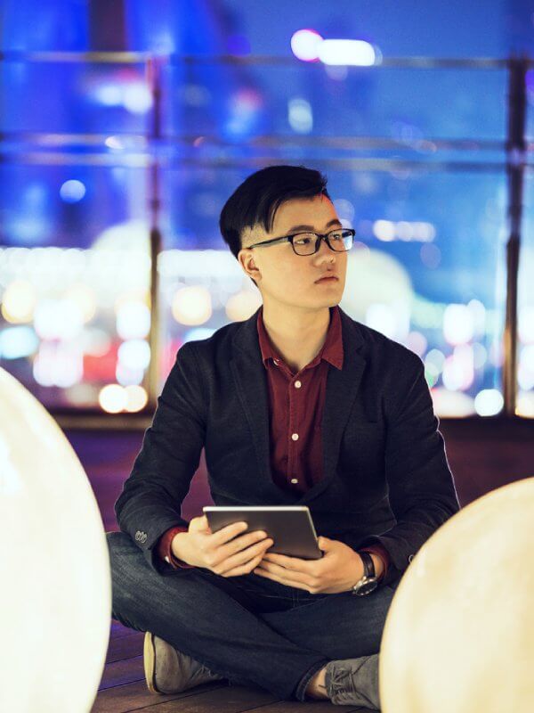 Smartly dressed man using a tablet in public