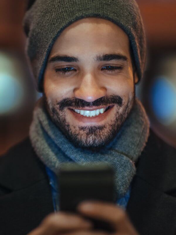 Man smiling at his phone