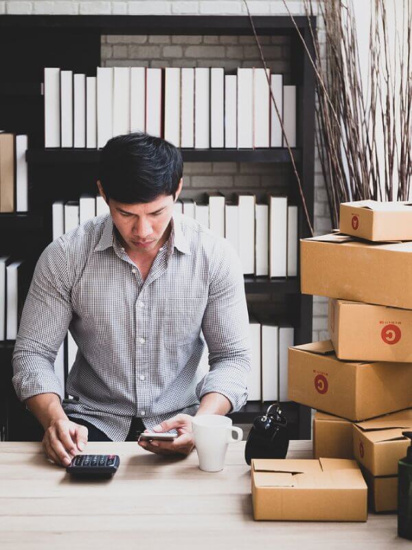 Man mailing parcels out to his customers