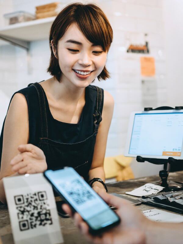 Customer at a store scanning a QR code