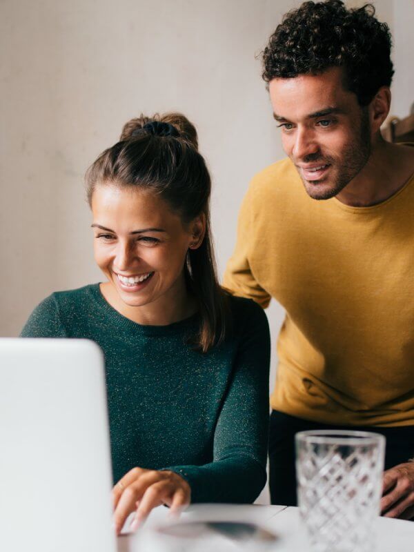 Young couple applying for credit on a laptop