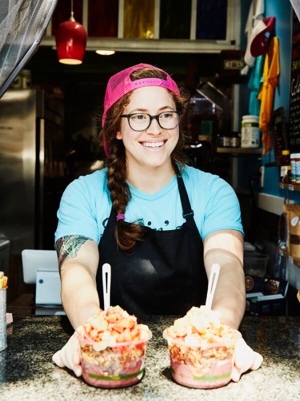 Small business owner with desserts in a store