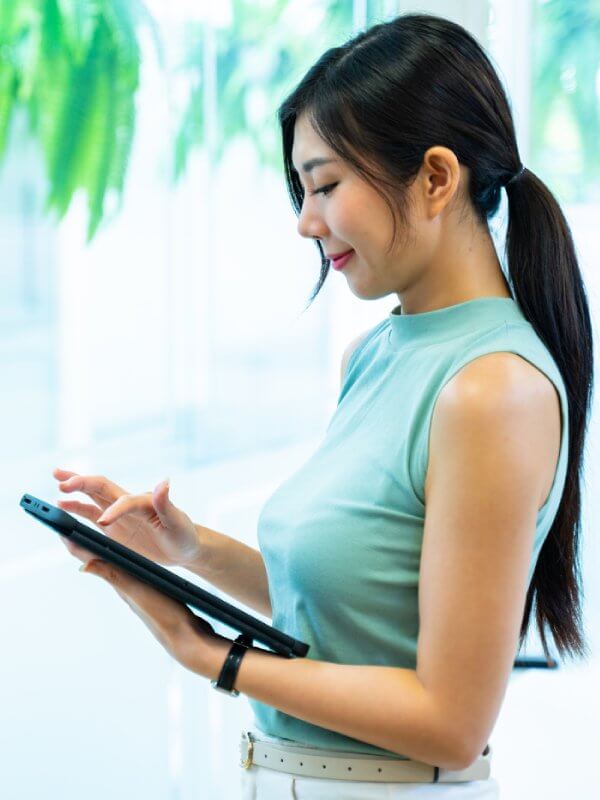 Young woman in an office using a tablet