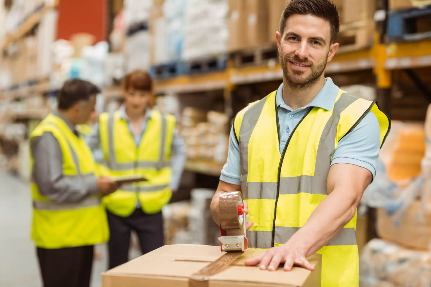 Man wearing hi-vis vest working in a warehouse