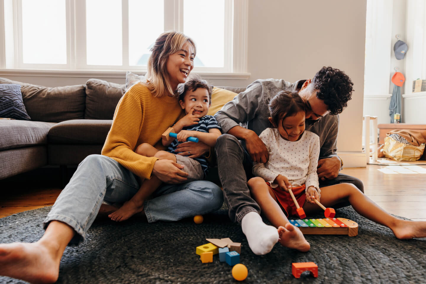 Couple and two young children playing on floor