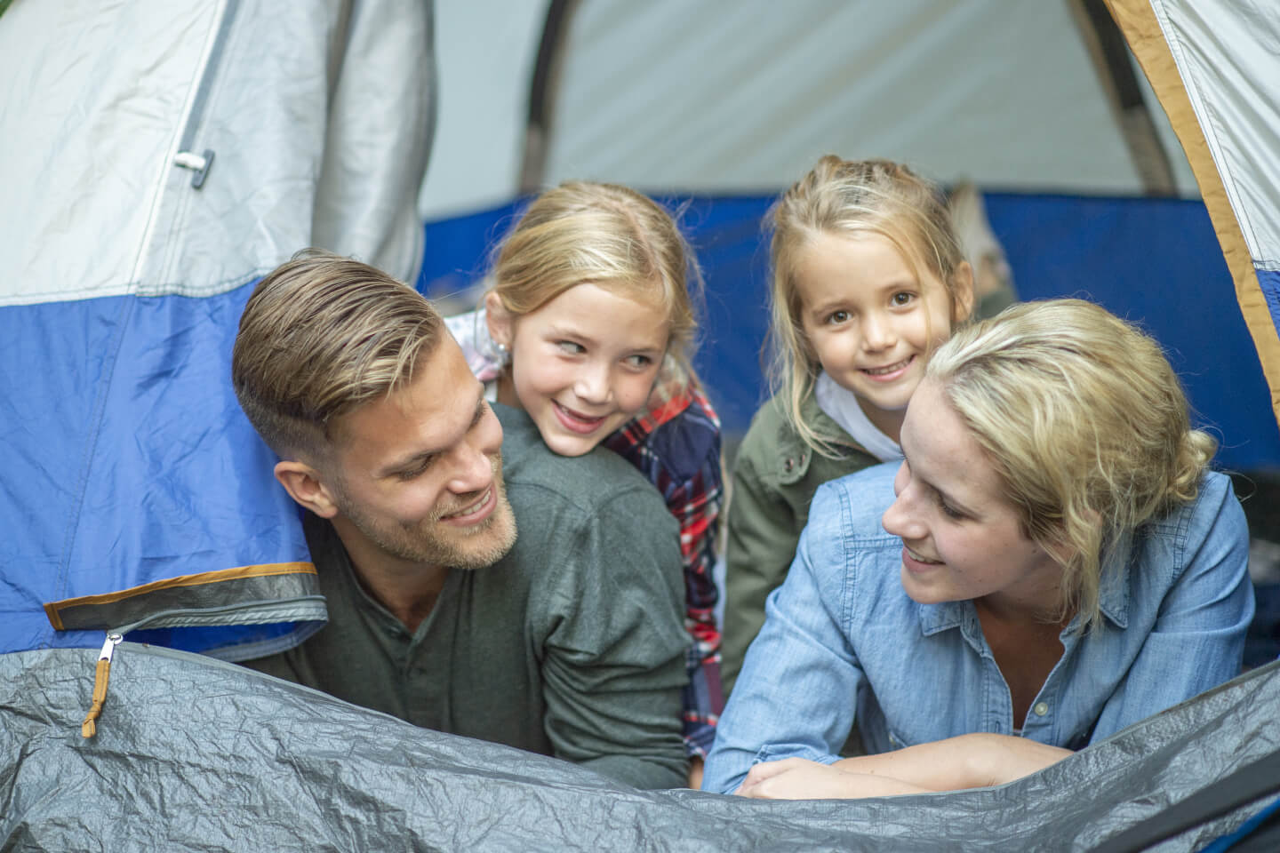 Couple and two young children in tent