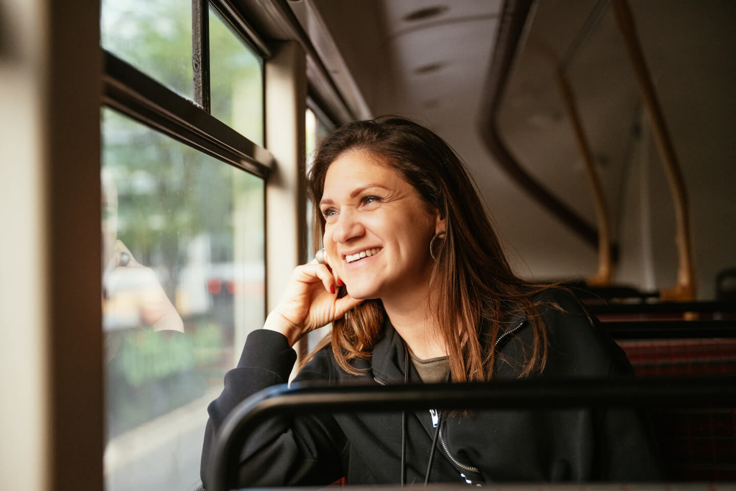 Woman sat on bus looking out window