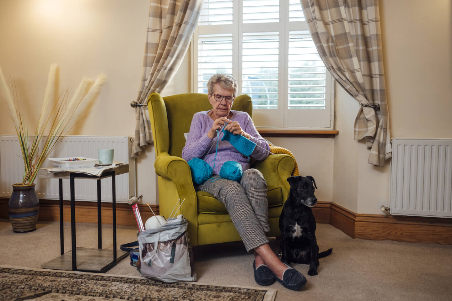 Elderly woman sat knitting