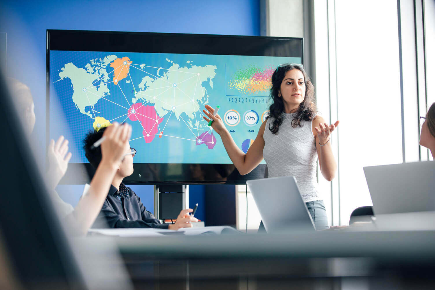 Woman giving a presentation showing international markets